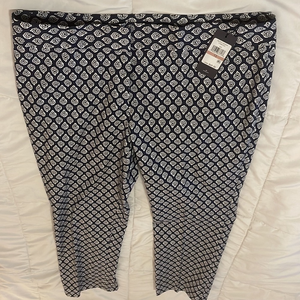 Floral print pants with zipper front, tapered leg, lightweight cotton fabric.